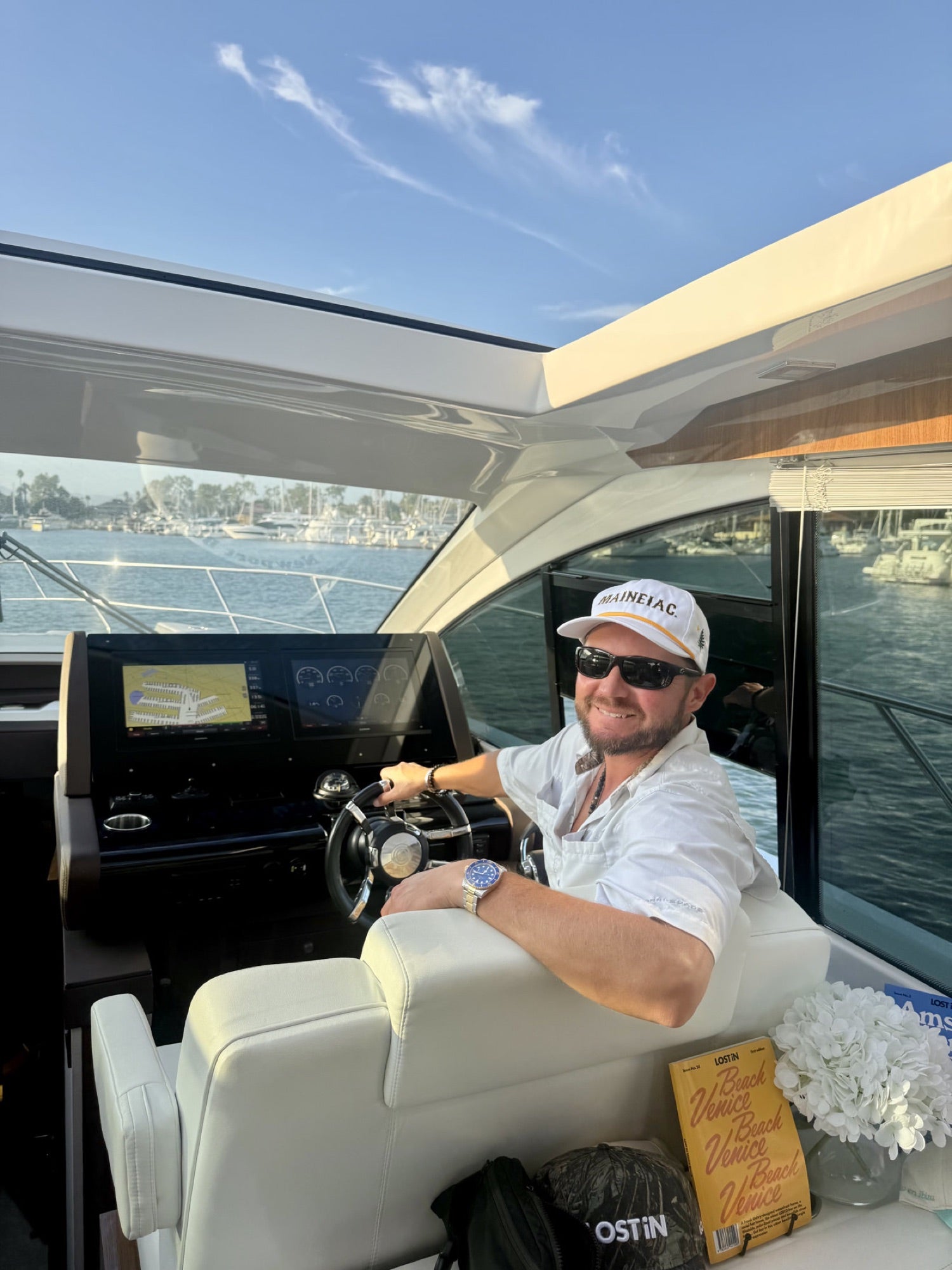 Captain Charles Shriner III at the helm in a Maineiac cap